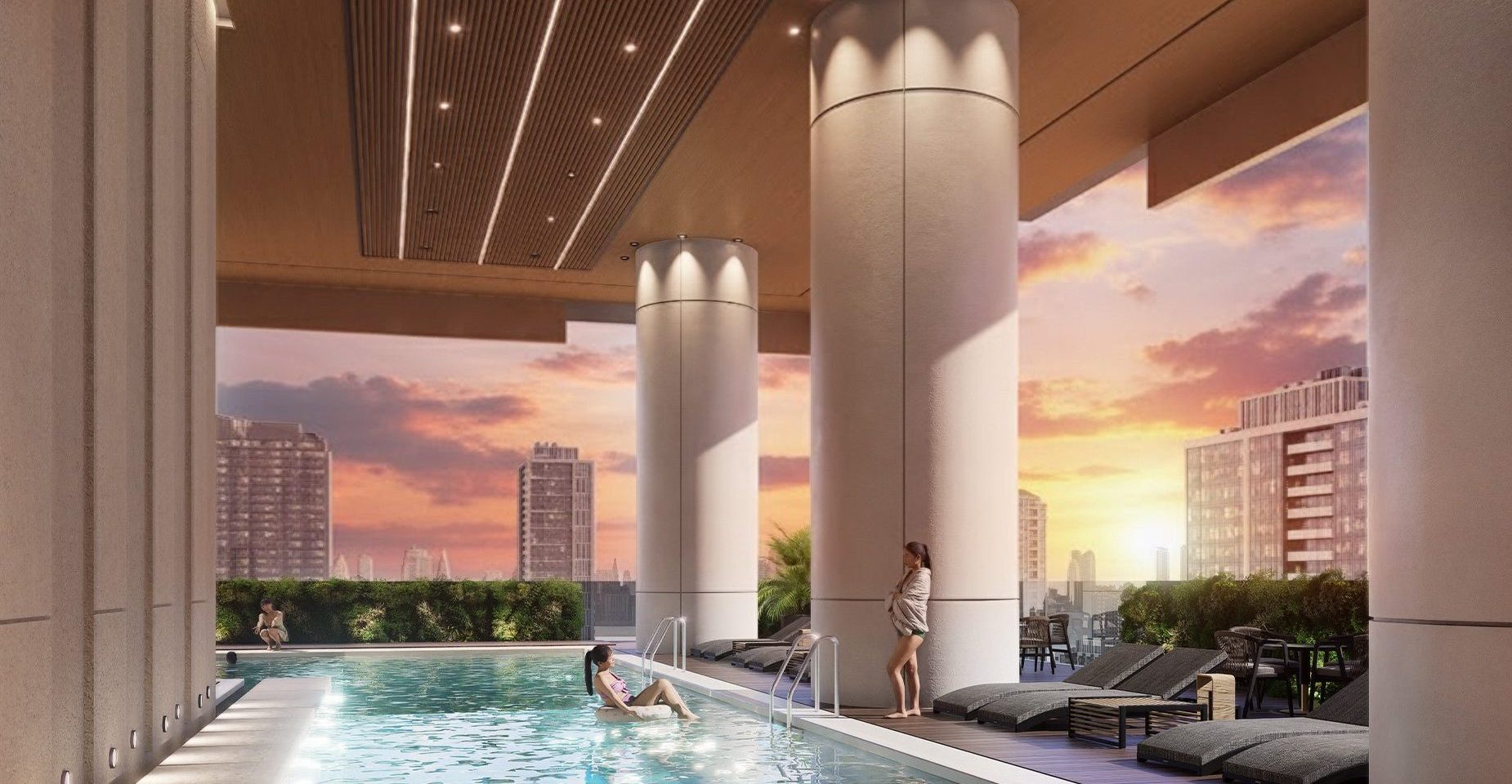 Rooftop pool deck at sunset, with skyline views
